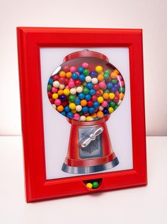 a red frame with a gumball machine in it