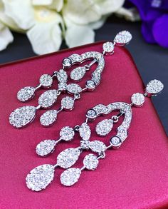 HANDCRAFTED TO PERFECTION! SPECIAL AND LOVELY FLORAL DESIGN, ILLUSION SETTING (APPEARS TO BE LIKE A 0.5-1.0 CARAT BRILLIANT PEAR Diamonds). With over 128 pieces of UNTREATED AND GENUINE F/VS QUALITY SPARKLING DIAMONDS! Perfect for every event! SET IN 18K SOLID WHITE GOLD HANDCRAFTED, CHANDELIER EARRINGS! SUGGESTED RETAIL VALUE: $11,000 DIAMONDS: 254 ROUND BRILLIANT, FULL CUT with excellent firing diamonds, weighting at 3.50 carats. ALL NATURAL, UNTREATED DIAMONDS. ALL DIAMONDS HAVE NO VISIBLE IN White Gold Drop Chandelier Earrings For Evening, Fine Jewelry Teardrop Chandelier Earrings For Wedding, Teardrop Chandelier Earrings For Wedding, Luxury Diamond White Chandelier Drop Earrings, Formal Cubic Zirconia Dangle Chandelier Earrings, Formal Cubic Zirconia Chandelier Earrings, Formal White Chandelier Earrings With Sparkling Stones, Exquisite White Gold Chandelier Earrings With Cubic Zirconia, Exquisite White Gold Cubic Zirconia Chandelier Earrings