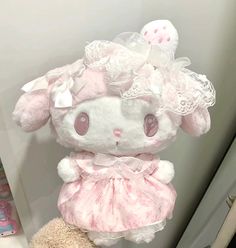 a stuffed animal wearing a pink dress