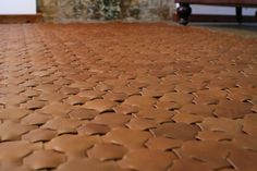 a close up view of a brown leather floor with an old brick wall in the background