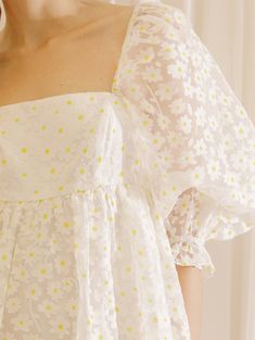 The Daisy Baby Doll Mini Dress is the perfect piece for those special bridal events this spring and summer. Featuring a detail white dress with a touch of yellow of Daisy print and a gathered empire waist, this elegant dress is made from sheer fabric with an underlined design for added coverage. With a back/front square neckline, bust darts, and oversized 3/4 puffy sleeves with ruffled cuffs, you'll feel comfy and stylish. Material:Cotton and Polyester White Daisy Dress, Bridal Events, Net Dress, Daisy Dress, Long Frocks, Bridal Event, Daisy Print, Puffy Sleeves, Sheer Fabric