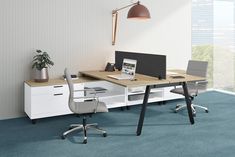 an office desk with two chairs and a laptop on it