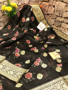 With detailed digital print work done with intricate detail makes this designer collection one of the sorted and unique buys to try for any light occasion or party in a great onyx black color. It is beautifully paired with woven zari work on the border and the pallu and mandala butta work on the body makes this saree unique. Color: A shade of onyx black color Technique: Amazing work of traditional zari weaving on the whole saree with digital floral print work on the body Fabric: Organza Quality: Designer Chanderi Blouse Piece With Floral Print, Party Georgette Blouse Piece With Printed Motifs, Elegant Blouse Piece With Printed Motifs, Party Blouse Piece With Traditional Drape And Printed Motifs, Traditional Designer Wear Blouse Piece With Floral Print, Georgette Saree With Printed Motifs For Party, Traditional Designer Blouse Piece With Floral Print, Traditional Blouse Piece With Floral Print For Designer Wear, Semi-stitched Black Art Silk Blouse Piece