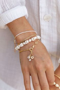 Three tiny natural puka shells dangle from this dainty gold-filled bracelet. This gold multi strand beauty embodies the laid-back energies of Hawaii. ✦ DETAILS ✦ ✧ Name: Kaihohonu - (KAEE ho HO noo) - deep sea, high tide. ✧ One size fits most. ✧ 18kt gold filled with lobster clasp. ✧ Natural puka shells. ✧ All Ke Aloha Jewelry pieces come packaged thoughtfully, beautifully, and ready for gift giving. ✦ MORE GOLD BRACELETS ➤ https://www.etsy.com/shop/kealohajewelry/?section_id=11533635 ✦ Sign up Dainty Adjustable Chain Bracelet For Beach, Dainty Adjustable Bracelet For Beach, Dainty Adjustable Beach Bracelet, Dainty Bracelet With Adjustable Chain, White Bohemian Bracelet With Adjustable Chain, Charm Bracelet Gold, Hawaii Jewelry, Gold Chain Bracelet, Layered Chain