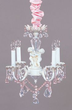 a white chandelier with pink roses on it