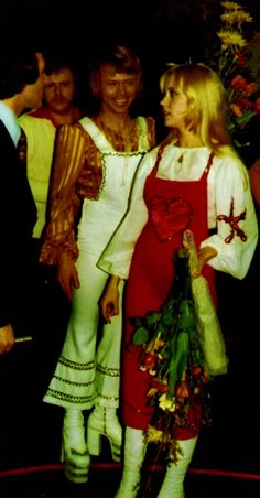 three people dressed in costumes standing next to each other and giving the thumbs up sign