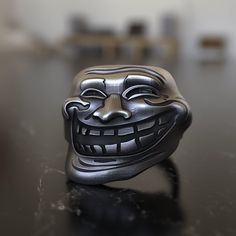 a metal mask sitting on top of a table