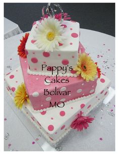 there is a two tiered cake with flowers on it