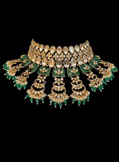 Tiana I - Indian Bridal Set w/ Emerald Drops, Kundan & Green Meenakari work Stunning modern choker necklace for Indian brides with Kundan stone setting. Fit for any fashionista who appreciates the beauty of fine craftsmanship and design all in one stunning set! Stunning green Meenakari work adorns this bridal set in square-shaped metal detail. This set is elaborated with moon design detailing of Kundan gems. This classic bridal jewelry is further accented with mini green emerald stone drops at t Elegant Kundan Choker Necklace For Ceremonial Occasion, Elegant Kundan Choker Necklace With Tilla, Tilla Choker Jewelry For Reception, Tilla Choker For Reception, Tilla Choker For Reception Occasion, Elegant Hand Set Choker For Ceremonial Use, Elegant Hand Set Choker For Ceremonial Occasions, Elegant Ceremonial Hand Set Choker, Formal Bridal Choker With Tilla