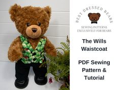 a brown teddy bear wearing a green shirt and black pants sitting next to a potted plant