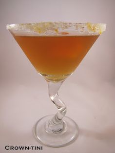 a glass filled with a drink sitting on top of a table