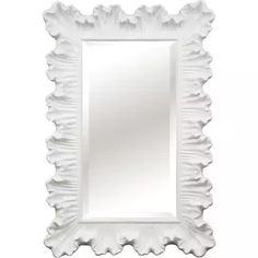 a large white mirror with scalloped edges