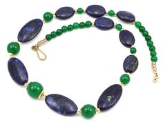 "An elegant blue and green gold necklace featuring 29x15x6mm and 18x13x6mm Blue Lapis flat oval beads. The Lapis are separated with 12mm and 9mm Green Jade round beads capped in 14KGF. Round 6mm Green Jade leads to a 14KGF hook & eye clasp. SPECIFICATIONS  * Necklace weight:  54 grams (1.9oz)  * Size: 19.5\"  * Metals: 14K Gold Filled  * Main beads: Blue Lapis, Green Jade _ _ _ _ _ _ _ _ _ _ _ _ _ _ _ _ _ _ _ _ _ _ _ _ _ _ _ _ _ _ _ _ _ _ _ _ _ _ _ _ _  See my shop listing for my other great des Elegant Blue Oval Beads Jewelry, Elegant Blue Oval Beaded Jewelry, Elegant Green Oval Beaded Necklaces, Elegant Green Oval Bead Necklaces, Elegant Green Necklaces With Oval Beads, Elegant Green Oval Beads Jewelry, Elegant Blue Oval Cabochon Necklace, Gold Beaded Necklace With Polished Beads, Gold Oval Polished Beads Necklace