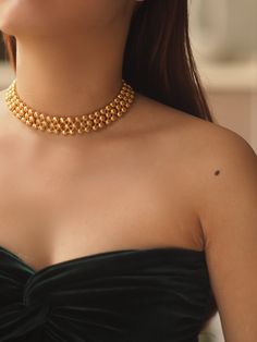 Description: Elevate your style with the timeless elegance of our Tayah Golden Beaded Choker Necklace. This exquisite piece is crafted from high-quality brass with a gold plating finish, creating a luxurious and durable design. Featuring a series of perfectly polished gold beads, the necklace is designed to sit gracefully on the collarbone, adding a touch of sophistication to any outfit. The adjustable extension chain ensures a comfortable and customizable fit, making it ideal for both everyday wear and special occasions. Details: Material: Gold-plated brass Length: 31 cm with an 8 cm extension chain Weight: Approximately 57g Care Instructions: Avoid direct contact with water, perfumes, and chemicals to maintain the necklace's shine and longevity Pearl Jewelry Necklace, Natural Stones Necklace, Gold Statement Earrings, Natural Stone Jewelry, Natural Stone Bracelets, Beaded Choker Necklace, Anklet Bracelet, Anklet Jewelry, Cord Necklace