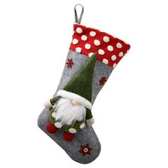 a christmas stocking with a santa clause on it's side and polka dots