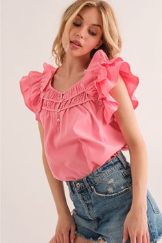 It features smocked detailing, which refers to a technique where fabric is gathered and stitched in a stretchy and elastic manner. The smocked sections of the blouse create a fitted and textured appearance, adding visual interest and enhancing the overall design. The relaxed fit makes it suitable for various body types and can be easily paired with different bottoms for versatile styling options. The blouse is a versatile piece that can be dressed up or down. It can be paired with tailored pants Pink Tops With Smocked Back And Ruffled Straps, Feminine Pink Blouse With Smocked Cuffs, Pink Smocked Back Blouse For Spring, Spring Pink Blouse With Smocked Back, Pink Blouse With Smocked Back For Spring, Pink Feminine Top With Smocked Back, Feminine Pink Tops With Smocked Back, Feminine Pink Blouse With Smocked Back, Pink Smocked Bodice Blouse For Spring