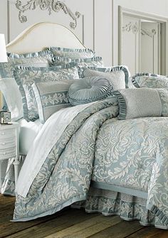 the comforter is made up with blue and white bedding