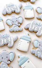 decorated cookies are arranged in the shape of baby's first and second name letters