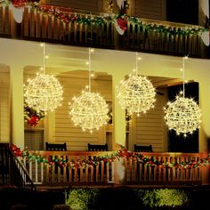 christmas lights hanging from the side of a house in front of a porch with stairs