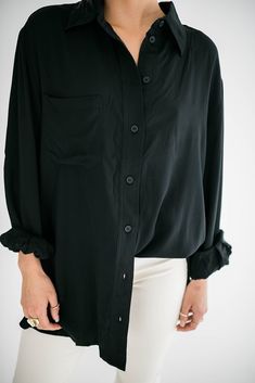 A timeless wardrobe essential that seamlessly combines style and comfort. Our Marino button up is designed with a modern, relaxed fit that drapes perfectly, providing a flattering silhouette for all body types. Size Chart Features: oversized fit collared neckline buttons front pocket buttoned cuffs fabric content: 100% rayon model is wearing a small. Height 5'7" Bust 34", Waist 25", Hip 36" Chic Shirt With Roll-up Sleeves For Everyday, Modern Collared Blouse With Button Closure, Fall Collared Blouse With Hidden Button Closure, Chic Shirt With Hidden Button Closure For Fall, Chic Fall Shirt With Hidden Button Closure, Button-up Rayon Shirt With Button Closure, Viscose Button-up Shirt With Button Cuffs, Sleek Collared Top With Button Closure, Sleek Tops With Button Closure And Lapel Collar