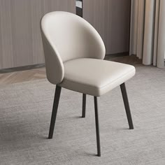 a white chair sitting on top of a carpeted floor