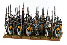 a group of painted warhammers with swords and spears on their heads, standing in front of each other