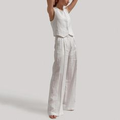 Discover Elegance and Comfort with Our Chic Summer Set Embrace the warmth of summer and the demands of a professional lifestyle with our Chic Cotton Linen Summer Vest & Pants Set. This beautifully tailored two-piece ensemble is the epitome of elegance and comfort, making it a must-have in your wardrobe. Whether it's for a day at the office or a casual outing, this set ensures you look effortlessly stylish and feel comfortable all day long. Product Features High Waist Design: Flatters your figure, providing a slimming and sophisticated silhouette. Pleated Front Style: Adds a touch of elegance and refinement to your look. Natural Fiber Composition: Made from high-quality cotton and linen, ensuring breathability and durability. Contemporary Office Lady Style: Perfectly blends professionalism Tailored Summer Sets For Workwear, Tailored Sets For Summer Workwear, Tailored Summer Workwear Sets, Classic Summer Workwear Sets, Summer Tailored Linen Pantsuit, Tailored Linen Pantsuit For Summer, Tailored Casual Summer Sets, Elegant Summer Sets With High-waisted Pants, Summer Linen Sets With Straight Pants