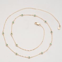 Gwen Timelessly beautiful, glistening Emeralds appear to float on your neck, with refined elegance. You will immediately feel like royalty! The classic station necklace will be your go-to, and truly never goes out of style as it just enhances your natural beauty. Also, it’s such an easy style to layer with other dainty necklaces. May’s birthstone, this stunning necklace will be the perfect gift for a woman of any age! - Handmade- Solid Gold- Natural Emerald- Bezel Size: 3 mm- Space Between the B Luxury Green Diamond Necklace With Gemstone, Luxury Green Gemstone Diamond Necklace, Luxury Green Diamond Gemstone Necklace, Green Diamond Necklace For Formal Events, Luxury Green Diamond Necklace For May Birthstone, Formal Green Diamond Necklace For May Birthstone, Green Emerald Diamond Necklace For May Birthstone, Green Diamond Necklace In Fine Jewelry Style, Fine Jewelry Green Diamond Gemstone Necklace