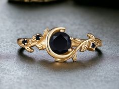 a black diamond ring sitting on top of a table