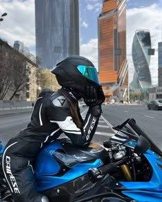 a person on a blue motorcycle in the city