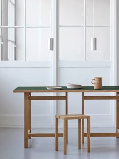 a table with two chairs and a coffee cup on it