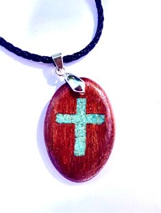 Looking for a unique personalized gift? This cross necklace is made from your choice of gorgeous woods.  The wood oval is roughly 1.4" tall by 1.1" wide.  The inlay is real turquoise stone sourced in the US.  The finish consists of multiple coats of gloss spar urethane.  This variety of urethan is great for wooden jewelry.  Designed for boats, it holds up very well against the elements and wear.  It also provides uv protection to reduce fading of the wood's natural tone.   The necklace cord is a Spar Urethane, Wood Burning Pen, Turquoise Cross, Real Turquoise, Unique Personalized Gift, Wood Pendant, Oval Pendant, Necklace Personalized, Wooden Jewelry