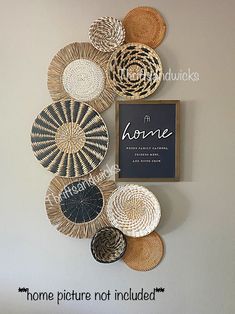 some baskets are hanging on the wall and there is a sign that says home pictures not included