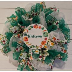 a welcome wreath hanging on the side of a wall