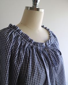 a mannequin wearing a blue and white checkered dress