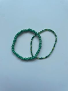 Stretchy bracelet set (2) - multi-green seed bead bracelet, medium sized dark green bracelet These bracelets come in a set of two. They are meticulously handmade with seed beads and stretchy string. The bracelet is triple knotted and glued shut, making a very durable bracelet. DISCLAIMER ON RETURN/EXCHANGE POLICY ~ Slightly mis-shaped bracelets due to knotting of the stretchy string is NOT INCLUDED in the return/exchange policy ~ Stretched out bracelets due to use over time is NOT INCLUDED in the return/exchange policy ~ Only broken beads or broken string within the return/exchange policy window ARE INCLUDED in the return/exchange policy Dark Green Beaded Bracelet, Green Beaded Bracelet With Spacer Beads For Friendship, Green Tiny Beads Friendship Bracelets, Green Heishi Beaded Colorful Friendship Bracelets, Handmade Green Heishi Beads Bracelets, Green Heishi Beads Bracelet With Colorful Beads, Green Colorful Beaded Bracelet, Adjustable Green Heishi Beads Bracelets, Adjustable Green Heishi Beads Bracelet