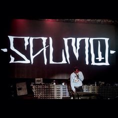 a man standing on top of a stage with the word lutuz written in white