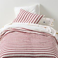 red and white striped bedding with polka dots on the comforter, pillows and pillowcases