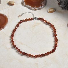 "Length: Shortest Length 14.5\"; Longest length 17.50\" . Major Beads: Faceted carnelian 6MM to 8MM. Style: Choker-style necklace. Clasp: Stainless steel lobster clasp and silver-plated extender" Brown Carnelian Gemstone Necklaces, Brown Carnelian Gemstone Necklace, Carnelian Round Beads Crystal Necklace, Round Carnelian Necklaces With Natural Stones, Red Faceted Carnelian Necklaces, Amber Carnelian Necklaces With Natural Stones, Amber Beaded Carnelian Crystal Necklaces, Adjustable Carnelian Gemstone Necklace, Brown Carnelian Gemstone Beaded Necklace