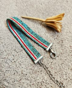 a pair of blue, red and white beaded lanyards on a chain