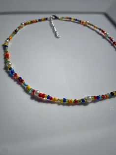 This trendy and bright beaded necklace has classy pearls scattered throughout the colorful beads. It is 16" with a 2" extension chain. Trendy Beaded Necklace With Tiny Beads For Parties, Trendy Tiny Beads Necklace For Party, Trendy Party Beaded Necklace With Tiny Beads, Multicolor Pearl Necklace With Colorful Beads For Party, Summer Party Beaded Necklaces With Round Beads, Party Beaded Necklaces With Letter And Round Beads, Party Letter Beaded Necklaces, Multicolor Pearl Beaded Necklaces For Parties, Multicolor Round Beads Pearl Necklace For Parties