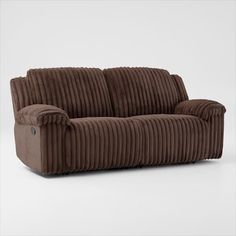 a brown corded couch sitting on top of a white floor next to a wall