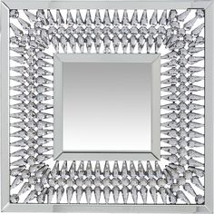 a mirror that has some kind of design on the front and side, with many small objects around it