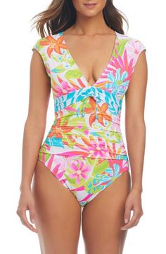 Cap sleeves frame this timeless one-piece swimsuit with a tie detail in front and a deeply dipped neckline. Deep V-neck Cap sleeves Full back coverage Lined 87% nylon, 13% spandex Hand wash, line dry Imported Fitted V-neck Tropical Tankini, Multicolor Fitted V-neck Swimwear, Multicolor V-neck Swimwear With Lined Body, Fitted Multicolor V-neck Swimwear, Multicolor V-neck Bodysuit For Poolside, Summer V-neck Ruched Bodysuit, Fitted Tropical Tankini With V-neck, Multicolor Ruched Swimwear, Vacation Mode