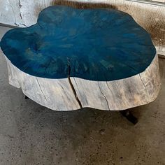 a wooden table with blue paint on it