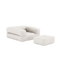 a white chair and ottoman sitting next to each other