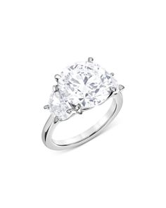 an oval diamond ring with two pear shaped diamonds on the shoulders and sides, set in white gold