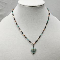 A beautiful, unique Czech Beaded Necklace that is eye-catching! Give this wonderful piece of jewelry as a gift for your mom, wife, or girlfriend.  SIZE  *Necklace Length - 18-24 inches *Pendant height - 1 inches *Pendant width - ¾ inches  ITEM DETAILS  *Material - Glass AQUA HEART WITH 3 COLOR CHAIN  *       A beautiful pressed Czech glass matte aqua opaque heart with a complementing goldish wash finish. *The chain is a 4mm multi-color beaded Czech chain with antique brass wire connecting the ch Heart Beaded Necklaces As Gifts, Heart And Round Beads Necklace For Gift, Elegant Heart-shaped Colorful Beads Jewelry, Elegant Heart-shaped Jewelry With Colorful Beads, Elegant Heart-shaped Colorful Beaded Jewelry, Double Heart Beads Necklaces For Jewelry Making, Blue Beaded Chain Charm Necklace As Gift, Heart Beads Pendant Necklace For Gifts, Blue Heart-shaped Jewelry With Colorful Beads