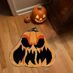 a halloween pumpkin shaped rug on the floor