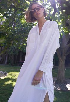 Eco friendly caftans and tunics inspired by the ocean, made on main street. Ethically sourced and locally made in Los Angeles. Inspired by French-girl chic and summers on the Cote d'Azur, meet our new favorite dress. Part shirt, part dress, part mens-wear inspired tunic, we love the oversized pockets, delicate pleats at the shoulder and generous cut. Like the majority of our dresses, this one has functional pockets, too. The cotton poplin is super soft and packs like a dream. With a shirt tail hem, pair this one with sandals or sneakers for elevated lounging or perusing your favorite market (whether its your local grocer or far away exotic bazaar). INSIDER TIP: This one is cut VERY roomy so please check the sizing tab for the best fit. Sheerness: noneFabric: 100% CottonMachine wash, hang, V-neck Relaxed Fit Shirt Dress For Vacation, Relaxed Fit V-neck Shirt Dress For Vacation, Long Sleeve Beach Dress For Summer, Long Sleeve Beach Dress For Summer Daywear, Oversized Spring Tunic For Daywear, Oversized Tunic For Spring Daywear, Relaxed Fit Tunic For Spring Day Out, Summer Style Tunic For Spring Daywear, Spring Summer Tunic